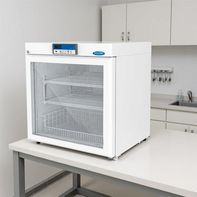 Nuline EC110 Pharmacy Refrigerator with Glass Door Closed Sitting on Laboratory Bench Angled Left Front View