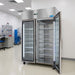 Nuline MF140TNG Laboratory Refrigerator with Glass Doors One Open Standing Against a Laboratory Wall Angled Left Front View