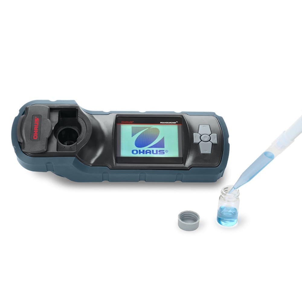 Ohaus Aquasearcher AP50MM Colorimeter Sitting on Flat Surface Left Side Top Front View with Opened 10ml Vial Filled with Blue Liquid to the Right Side with Pipette Drawing Out Liquid 